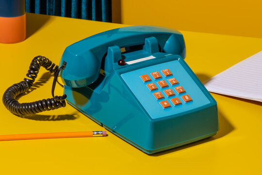 Retro phone on yellow desk