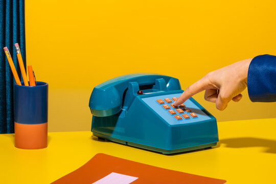 Person dialing number on phone