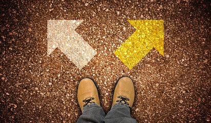 Yellow leather shoes and two right and left chalky arrows on ground - choice concept