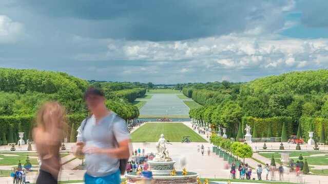 The Latona Fountain in the Garden of Versailles timelapse in France. View from above with tourists walking around at summer day. Boats on a pond