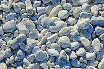 Marble pebbles of different sizes on the beach