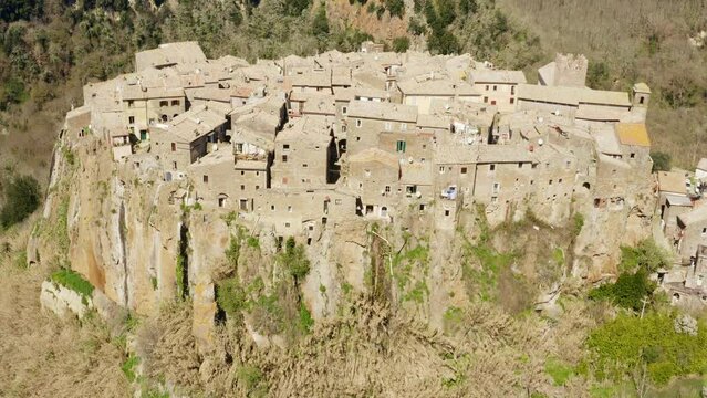 Aerial view of old town of Calcata, in the Province of Viterbo, Lazio, Italy. The town overlooking the valley of Treja. All houses have traditional red tiled roofs in the historical centre of Calcata.