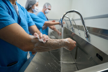 Team of surgeons washes their hands before the operation
