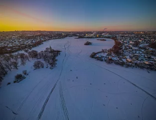 Fotobehang frozen river in winter city © Иван Сомов