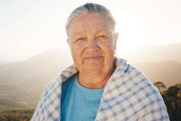 Portrait of the senior caucasian woman outdoor at sunrise. Model looks into the camera