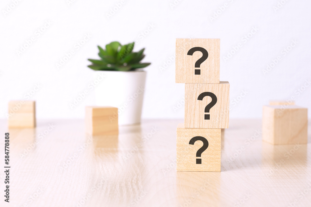 Poster three questions on wooden blocks in white background with copy space, learning concept.