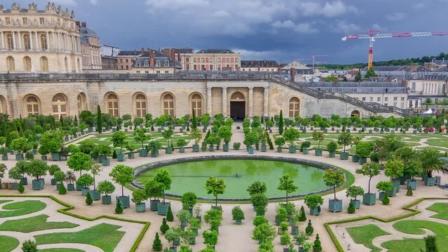 Famous palace Versailles with beautiful gardens and fountains aerial timelapse from top. The Palace Versailles was a royal chateau. Paris, France.