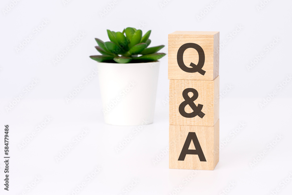 Aufkleber text qa on wooden blocks in white background with copy space