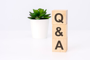text QA on wooden blocks in white background with copy space