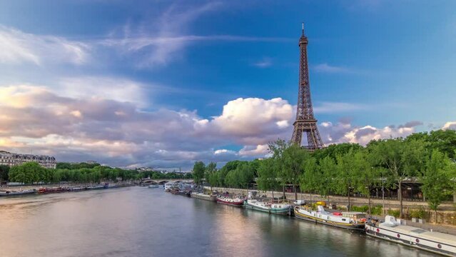 Eiffel Tower with boats at the evening timelapse hyperlapse Paris, France. Aerial view from Bir-Hakeim bridge before sunset. Blue cloudy sky at summer day