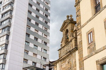 Fototapeta na wymiar Modern buildings along with very old ones coexist in the tourist city of Gijon, Asturias, Spain.