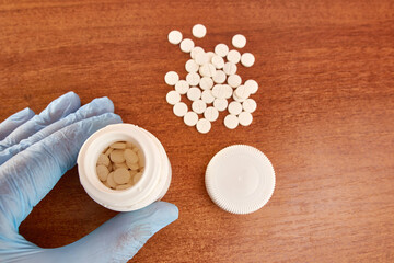 A pack of pills is scattered on the table. Overdose.