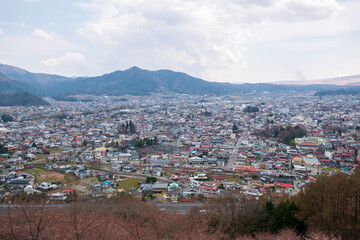 Fototapeta na wymiar View of the city of Kofu, Yamanashi, Japan downtown city skyline from the mountain