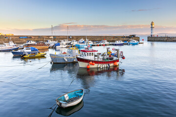 Sunrise at Newhaven Harbour on the Firth of Forth. Newhaven is a district in the City of Edinburgh, Scotland, between Leith and Granton and about 2 miles north of the city centre.