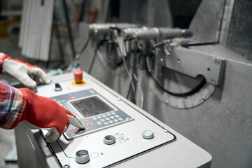 Male controlling information on electronic machine in the workshop