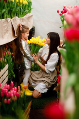 Mother and daughter are growing and selling tulips of many varieties. Mother's Day in the world....