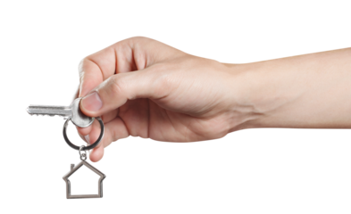Hand holding a house key, cut out