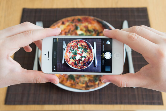 Taking an Instagram food photo of pizza with an iPhone camera on April 29, 2014 in England, UK