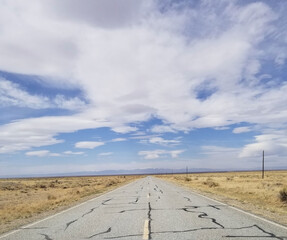 Open road in the desert with beautiful blue skies