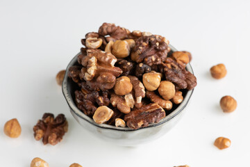 pile of mixed nuts in a ceramic bowl