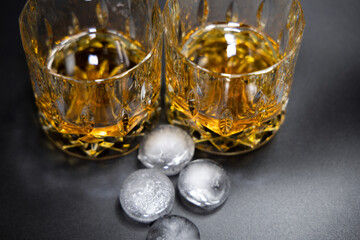 Two glasses of whiskey on a black background.High quality photo