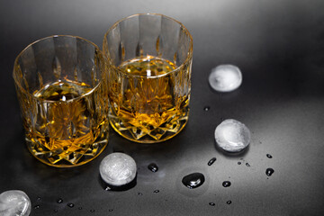 Two glasses of whiskey on a black background.High quality photo