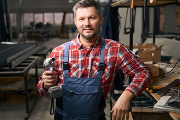 Portrait of employee ready to work in factory