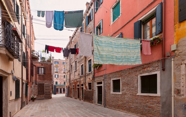 Fototapeta na wymiar Old narrow street in the historical part of Venice.