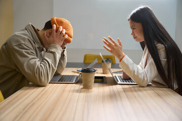 Company manager having difficult conversation with subordinate in meeting room