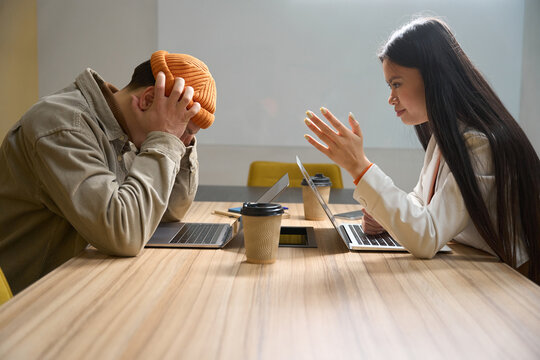 Company manager having difficult conversation with subordinate in meeting room