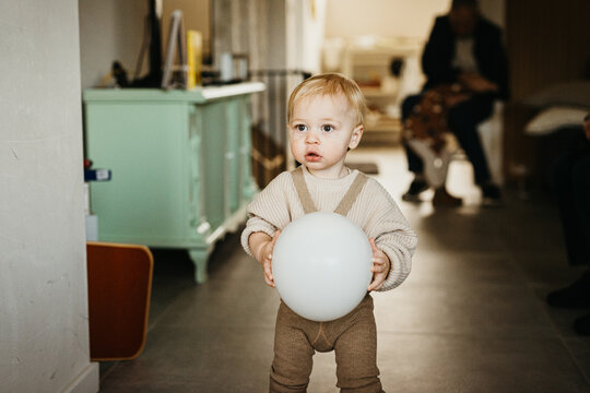 Picture of a sweet one year old holding a balloon