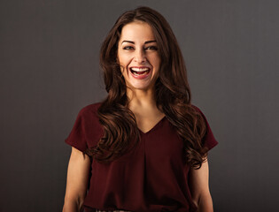 Beautiful fun happy toothy laughing business woman  on grey background with empty copy space. Closeup
