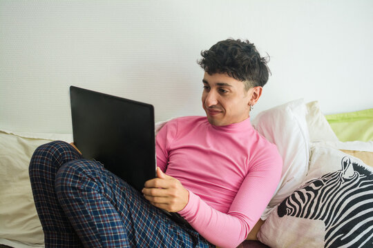 Non binary person using computer at home