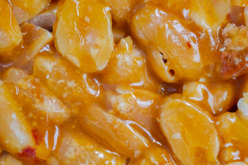 Close up, top view: caramelized nuts fried in honey - orange granola peanut bar - Gozinaki: macro....