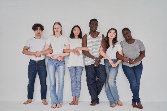 Diverse men and women locking arms