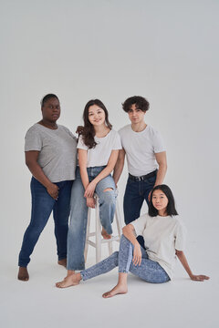 Diverse young people near stool