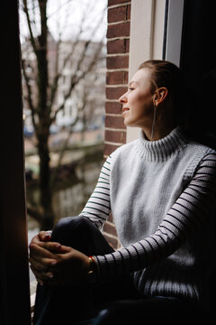 Woman relaxing and looking away  through window 