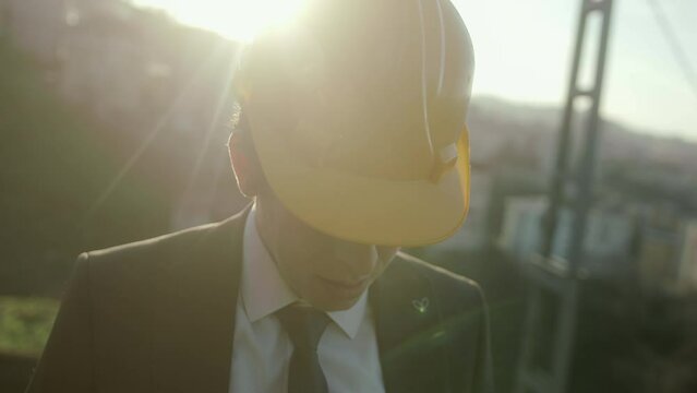Young Businessman or Engineer in a Beret Looking Down, Concept of Professional Misconduct