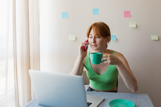 the girl misses the workplace and looks at the phone

