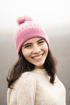 The face of a young woman smiling
