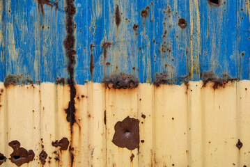 damaged blue yellow house wall war in Ukraine