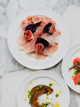 Burrata with roasted pumpkin and prosciutto with figs and parmesan