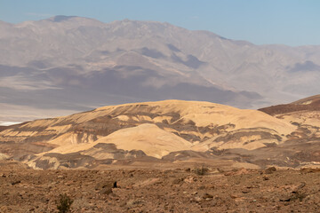Scenic view of colorful geology of multi hued Artist Palette rock formations in Death Valley National Park, Furnace Creek, California, USA. Black mountains and Amargosa Chaos seen from Artist Drive