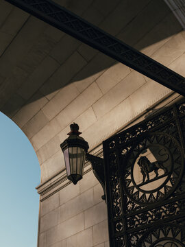 Cast iron metal gates and lamp on marble arch