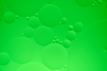 Abstract background with green oil circles on the water.