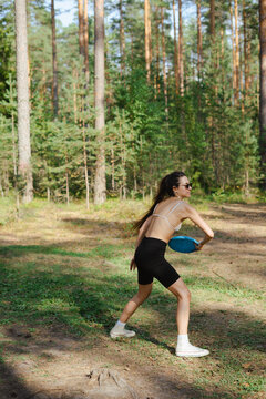 girl playing frisbee in nature