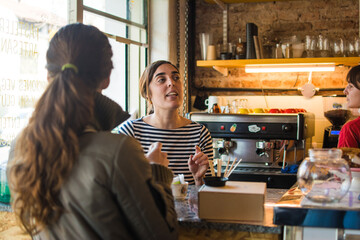 Coffee shop owner attending to a client
