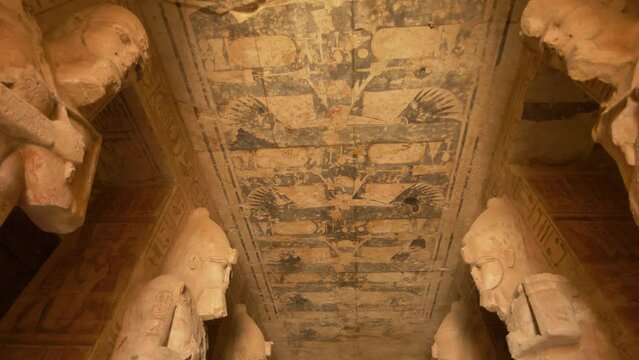 2022 - Low angle interiors of the Great Temple of Ramesses II in Abu Simbel, Egypt show sculptures and hieroglyphs on the ceilings.