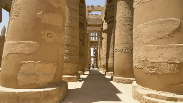 2022 - Low angle view of a thatched ceiling and columns covered in hieroglyphs at the Karnak Temple Complex.