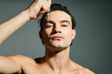 Beauty portrait of young man with healthy skin using beauty product